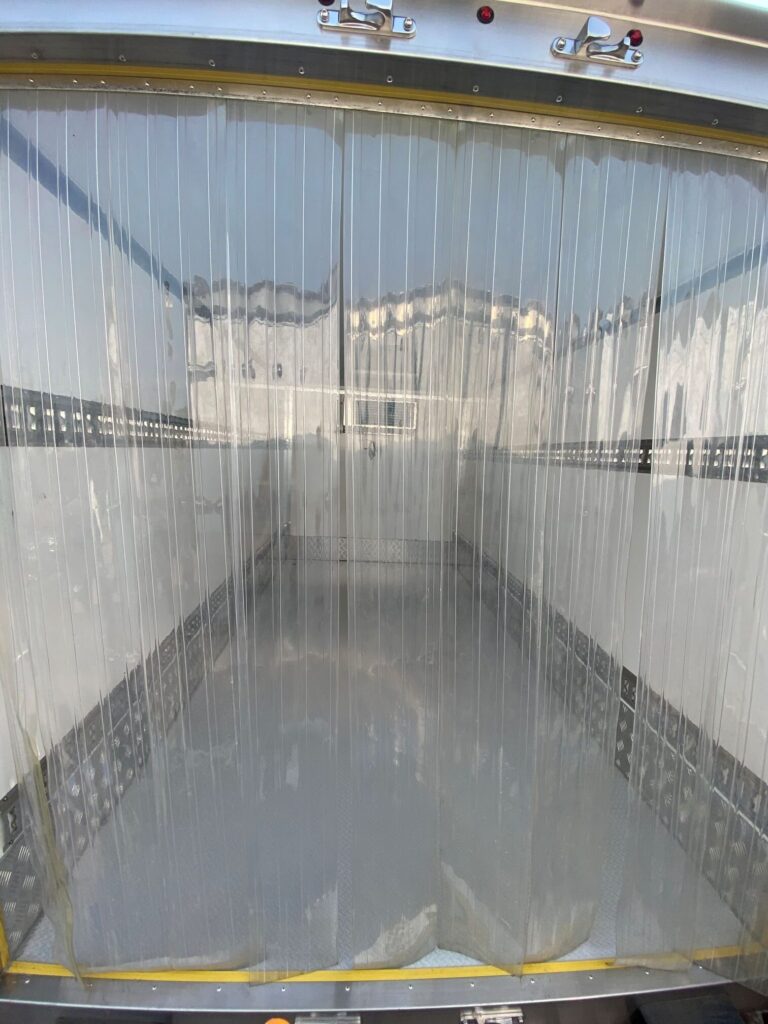 Rear of 2026 NEW Govi 7′ x 16' Seamless trailer inside view through plastic insulation flaps to interior of trailer.